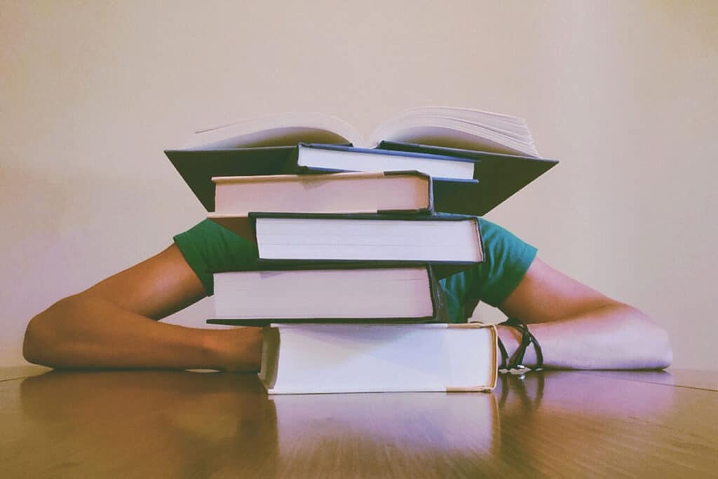 Student overwhelmed with books