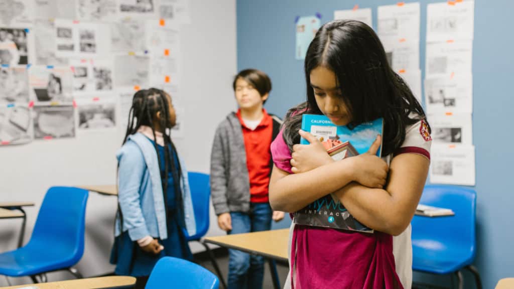 Anxious student holding book close