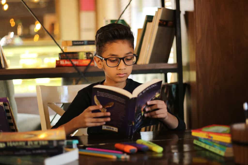 Boy reading a book in a library